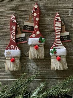 three christmas decorations hanging on a wooden wall