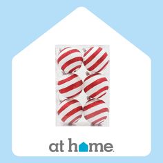 red and white striped christmas ornaments in a package with the at home logo below it