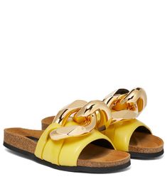 Our editors think these yellow slides from JW Anderson are the ideal balance of contemporary and classic design. Made in Spain from smooth black leather, they have open toes and leather linings for comfort. Chunky golden chain links are an exaggerated take on the label’s coveted nautical insignia. Luxury Leather Sandals With Logo Detail, Luxury Orange Leather Sandals, Luxury Yellow Leather Sandals, Luxury Designer T-strap Sandals With Leather Sole, Yellow Slides, Luxury Gold-tone Hardware Calf Leather Sandals, J W Anderson, Jw Anderson, Leather Slides