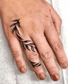 a person's hand with a tattoo on it