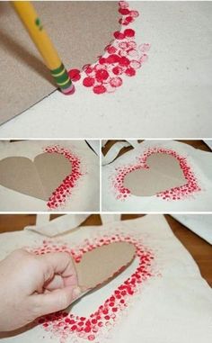 someone is making a heart out of paper and some red dots on the bottom half of it