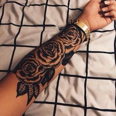 a woman's arm with a rose tattoo on it