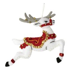 a white and red reindeer ornament hanging from a string