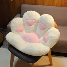 a stuffed animal chair with hearts on it