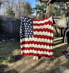 an american flag crocheted blanket hanging on a clothes line