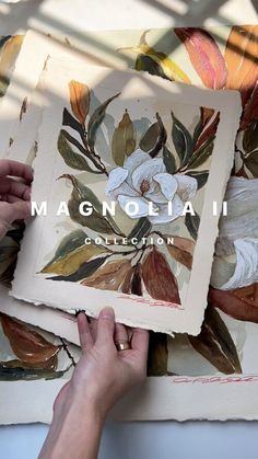 two hands are holding up paintings that have been painted with the words magnoliaii on them