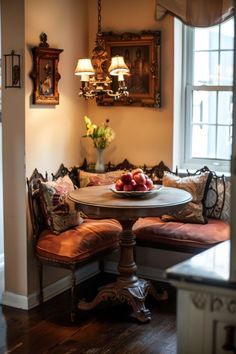 a table with fruit on it sitting in front of a window next to a couch