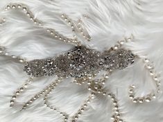 Absolutely Dazzling Finest Crystal Rhinestone & Pearl belt will take your breath away!Made with clear crystals with silver. Great to sewn onto your dress directly . Measurement :2.5 " widest point and 17" long  There is 3 yards long ribbon sash sewn underneath. Please contact us if you need to extend the crystal design .  Double face satin ribbon colors are available in White, Off White, Ivory, Silver, Royal Blue, Navy & Black.  If you want a different ribbon color, please convo me and I will source it for you.  Satin Ribbon/Sash Color - *Please specify the ribbon color of your choice during check out in the "NOTE" section. If I don't see any color name specified in the note section, Thank you for stopping by & Congratulations! :-) Elegant Silver Bedazzled Sash, Elegant Silver Bedazzled Sashes, Elegant Bedazzled Silver Sash, Elegant Bedazzled Silver Sashes, Elegant Silver Belt With Rhinestones, Adjustable Silver Belt With Bling, Adjustable Silver Belts With Bling, Elegant Silver Embellished Bridal Belt, Silver Adjustable Belt With Rhinestones