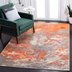 an orange and gray area rug in a living room with a green chair on the floor