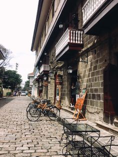 bicycles are parked on the side of an old building