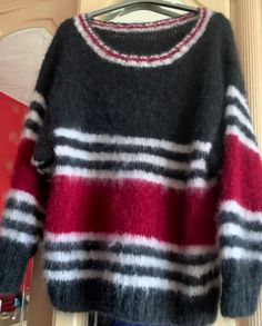 Mohair Sweater - Black, red and white stripe oversized sweater 50" This oversized sweater is a very straightforward hand knitted simple shape of sweater with drop sleeves and a scooped neck line. The things that make this sweater stand out are: The high quality of the yarn, and the contrasting colour-ways.  The garment is knitted in blocks of black and red with stripes of white. The red colour is more of a brick or garnet shade of red, rather than a bright red. It is not always to portray actual Oversized Striped Cozy Sweater, Cozy Oversized Striped Sweater, Oversized Striped Chunky Knit Sweater, Pull Mohair, Oversized Striped Sweater, Shade Of Red, Colour Ways, Mohair Yarn, Mohair Sweater