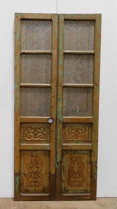 an old wooden door with glass panels on it