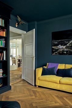 a living room filled with furniture and bookshelves