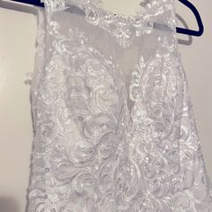 a white dress hanging on a hanger