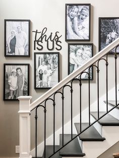 a staircase with black and white pictures on the wall