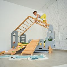 a young man is climbing up the stairs in his play room