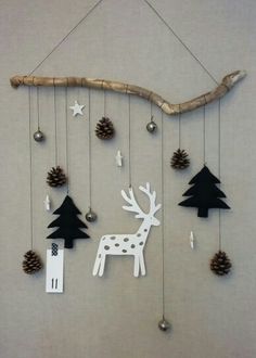 a mobile made to look like a deer with pine cones on it and other decorations