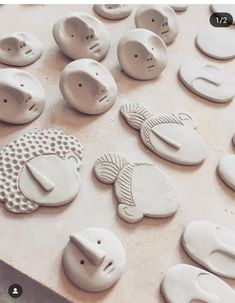 ceramic fish and sea creatures are displayed on a table with holes in the middle to make them look like they're made out of clay