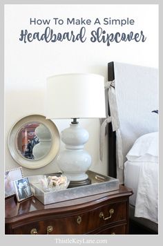 a nightstand with a lamp and pictures on it next to a white wall that says how to make a simple headboard slipover