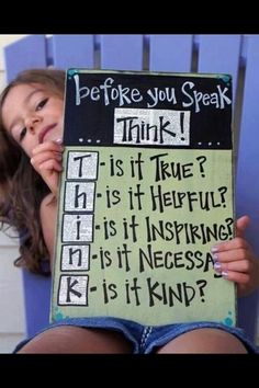 a woman holding up a sign that says, before you speak think is it true?