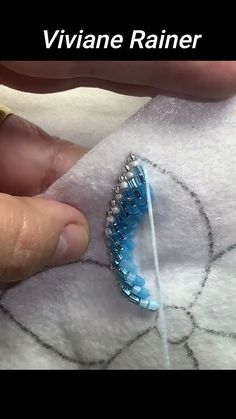 someone is stitching something on top of a piece of fabric