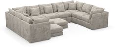 a large sectional couch and footstool with pillows on the back, sitting in front of a white background