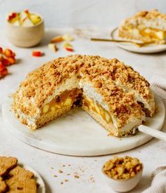 a cake that has been cut in half on a plate with some crackers around it