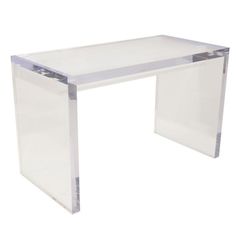 an acrylic desk with clear legs and a glass top on the bottom, against a white background