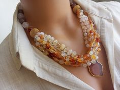 Meet our elegant Quartz - Agate Beaded Necklace, a collection of unique handcrafted jewelry that is sure to attract attention! This eye-catching necklace creates a striking visual with large gem stones in different shades of orange. Perfect as a gift for a beloved mother or wife, this statement chunky multi-strand natural stone summer accessory will add a bohemian touch to any outfit. CARE INSTRUCTIONS: To keep your necklace looking its best, avoid exposing it to harsh chemicals or excessive moi Unique Handcrafted Jewelry, Orange Agate, Jewellery Inspiration, Necklace Chunky, Mineral Stone, Gem Stones, Crystal Quartz, Summer Accessories, Agate Beads