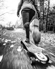 a person riding a skateboard down a wooden path