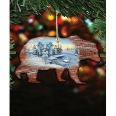 a bear ornament hanging from a christmas tree