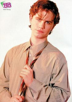 a young man is wearing a shirt and tie