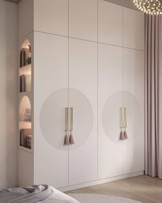 a bedroom with white cupboards and two round mirrors on the wall next to a bed