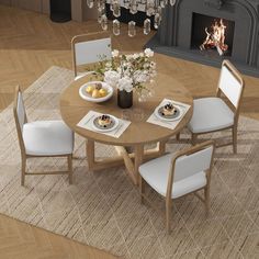 a dining room table with white chairs around it and a chandelier hanging from the ceiling