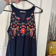 Size Small. Never Worn. Has A V Neck And Scoop Back. Hits Right Above The Knee. Beautiful Embroidery Summer Blue Embroidered Floral Print Dress, Blue Floral Print Embroidered Summer Dress, Blue Sleeveless Embroidered Beach Dress, Blue Embroidered V-neck Summer Dress, Casual Sleeveless Embroidered Dress With Floral Print, Blue Sleeveless Dress With Floral Embroidery, Blue Embroidered V-neck Dress For Summer, Casual Sleeveless Embroidered Floral Dress, Casual Sleeveless Floral Embroidered Dress