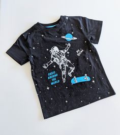 This shirt is out of this world with its cool design and vintage wash giving it that retro look. It is also one of the softest shirts around because of that vintage wash. Designed in LA Machine Washable Space-themed Graphic Crew Neck Tops, Space-themed Cotton T-shirt With Graphic Print, Space-themed Graphic Print Cotton T-shirt, Space-themed Cotton Crew Neck Top, Black Cotton Space-themed T-shirt, Space-themed Graphic Print Short Sleeve Tops, Space-themed Short Sleeve Top With Graphic Print, Black Cotton T-shirt With Space Theme, Cotton Grunge Tops With Character Print