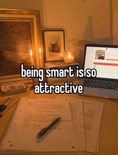 a laptop computer sitting on top of a wooden desk next to papers and candles with the caption being smart is so attractive