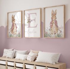 two framed pictures hang on the wall above a bench with pillows and baskets underneath it