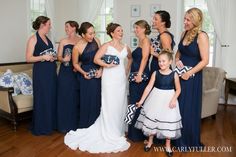 a group of women in dresses standing next to each other on a hard wood floor