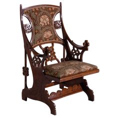 an ornate wooden chair with a floral upholstered seat