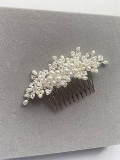 a close up of a hair comb with pearls