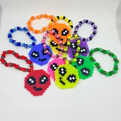 six pac - man beaded bracelets are arranged on a white surface with beads