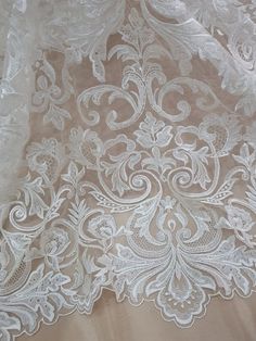 white lace on fabric with floral design