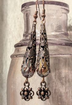 Stunning Victorian style earrings handcrafted using antique copper filigree bead cones, antique copper quatrefoil charms and ear wires and purple AB teardrop beads!! Perfect for a special occasion, costume or for everyday wear!! Length 3" Vintage Copper Teardrop Earrings, Antique Finish Copper Dangle Earrings, Antique Finish Copper Drop Earrings, Ornate Antique Finish Dangle Earrings, Ornate Bronze Filigree Earrings, Ornate Teardrop Chandelier Earrings Nickel Free, Ornate Copper Jewelry With Antique Finish, Ornate Teardrop Nickel-free Chandelier Earrings, Ornate Antique Finish Copper Jewelry