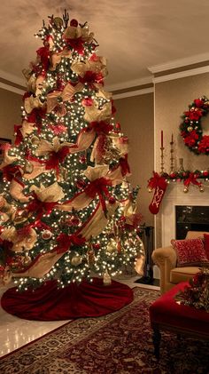 a decorated christmas tree in the middle of a living room with red and gold decorations