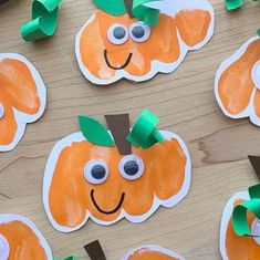 paper plate pumpkins with googly eyes and green leaves