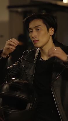 the young man is wearing a black leather jacket