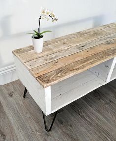 a wooden table with a flower pot on top