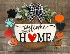 a welcome sign with pumpkins, leaves and other decorations on a wooden background that says welcome to your home