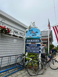 two bicycles parked next to a sign for bakery coffee breakfast luncheon